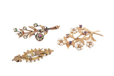 Lot 65 - Two gem set spray brooches, the first modelled...