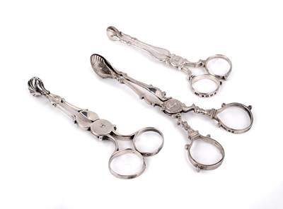 Lot 236 - Three pairs of silver tea tongs Of scissor...