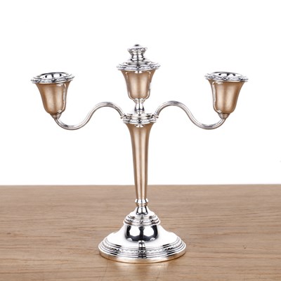 Lot 236A - Three-branch silver candelabra Standing on a...