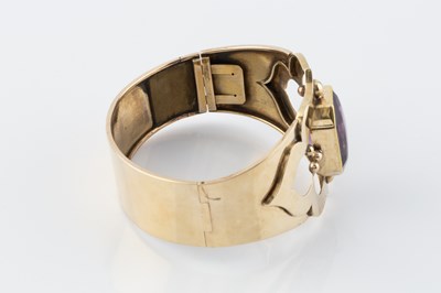 Lot 60 - An amethyst set bangle, the hinged oval bangle...