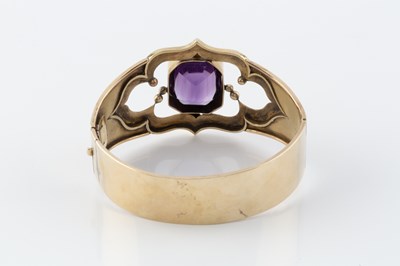 Lot 60 - An amethyst set bangle, the hinged oval bangle...