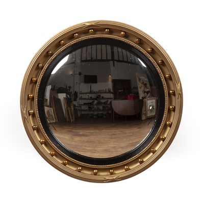 Lot 94 - Large gilded convex mirror in the Regency...