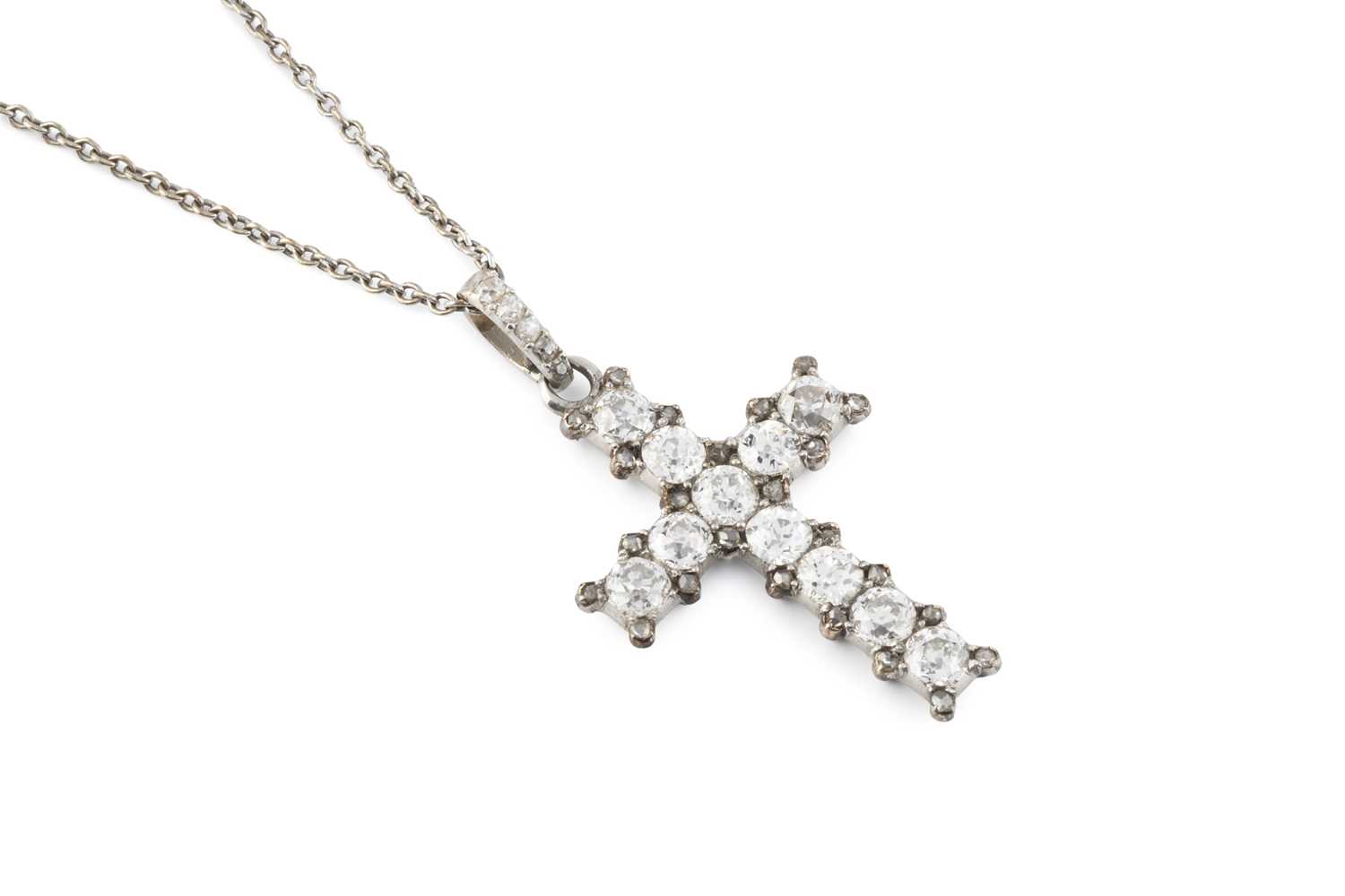 Lot A diamond cross pendant on chain, the...