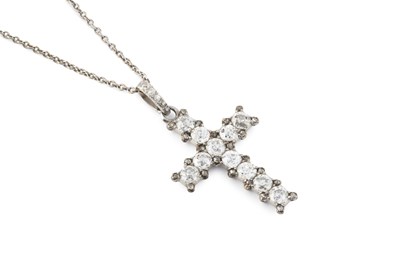 Lot A diamond cross pendant on chain, the...