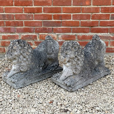 Lot 1346 - A pair of weathered recumbent lions