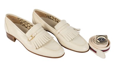 Lot 372 - A GUCCI pair of men’s loafers in white with...