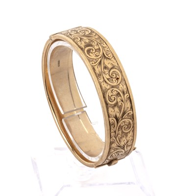 Lot 452 - 9ct gold bangle With scrolling engraved...
