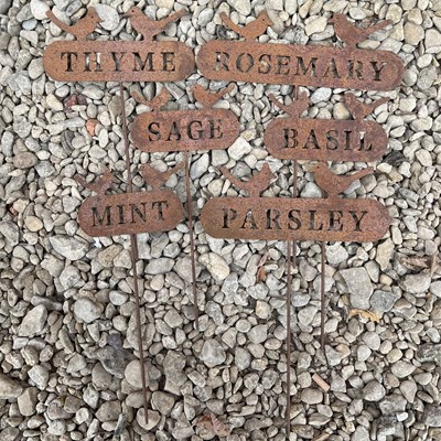 Lot 1344 - A set of six iron herb markers