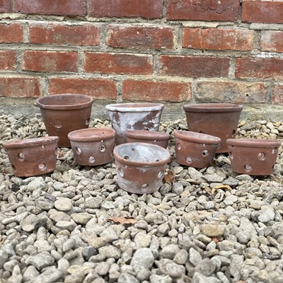 Lot 1375 - A group of nine hand-thrown terracotta orchid pots