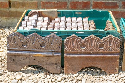 Lot 1282 - A set of fourteen Victorian treacle-glazed edging tiles