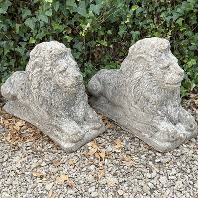 Lot 1377 - A pair of cast composite stone lions