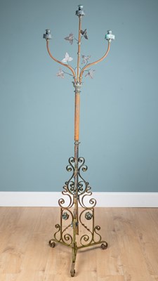 Lot 1189 - An early 20th century wrought iron three-branch candle stand