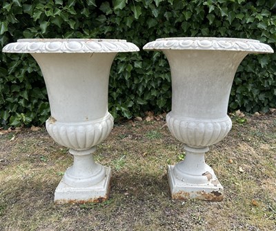 Lot A pair of white-painted cast iron urns