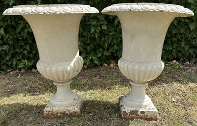 Lot A pair of white-painted cast iron urns