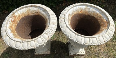 Lot A pair of white-painted cast iron urns