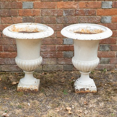 Lot 1359 - A pair of white-painted cast iron urns