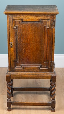 Lot 34 - A 20th century oak cupboard on stand