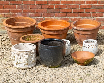 Lot 1283 - A group of three cast terracotta flowerpots, together with further planters