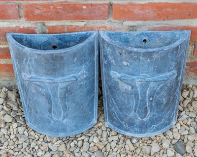 Lot 1328 - A pair of D-shaped tapering lead wall pockets or planters