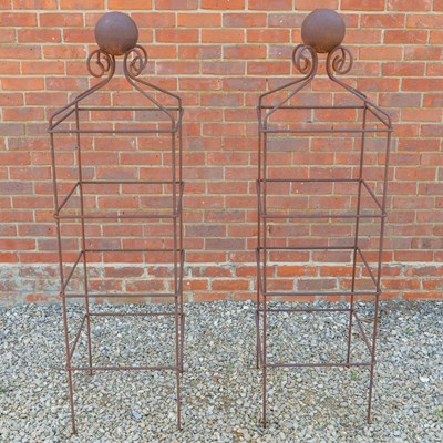 Lot 1250 - A pair of square scroll obelisk plant supports