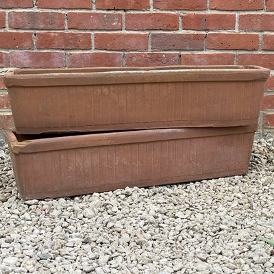 Lot 1285 - A pair of weathered terracotta planters