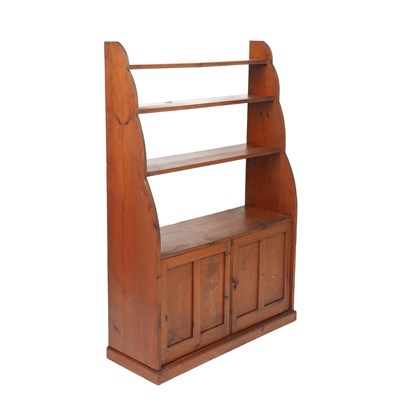 Lot 1118 - An early 20th century pine open-back waterfall bookcase