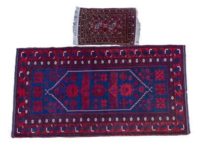 Lot 1190 - A mid-20th century hand-woven tribal rug