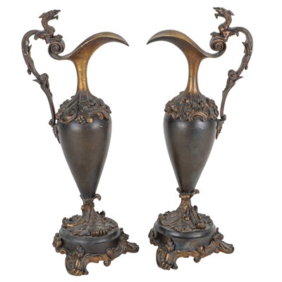 Lot 1323 - A pair of bronze ewers, together with two porcelain figural groups