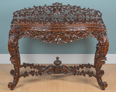Lot 1259 - A heavily-carved serpentine-fronted console table