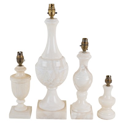 Lot 1307 - A collection of four alabaster table lamps