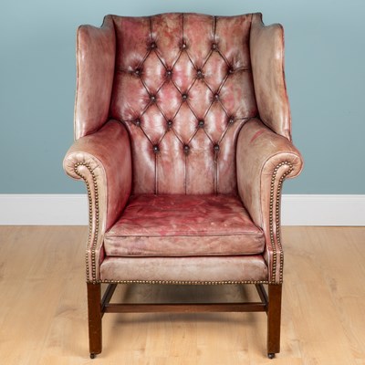 Lot 1358 - A red leather wingback armchair