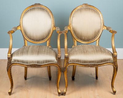 Lot 14 - A pair of gilt-framed oval-back open armchairs