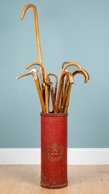Lot 1332 - An antique stick stand and a collection of seventeen walking sticks, canes, and parasols
