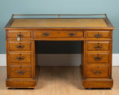 Lot 1335 - An early 20th century oak pedestal desk