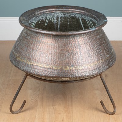 Lot 1098 - A hammered copper pot on stand