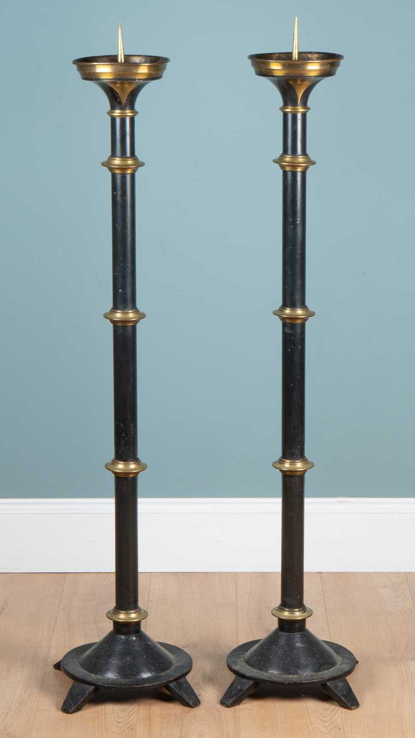 Lot 1143 - A pair of painted-steel floor-standing pricket candlesticks
