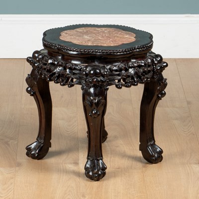 Lot 147 - A Chinese hardwood urn stand