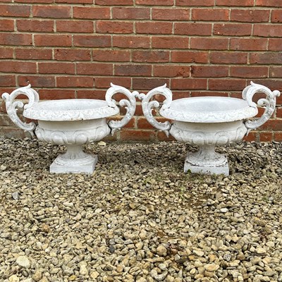 Lot 1052 - A pair of white-painted aluminium urns