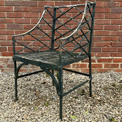 Lot 1050 - A cast iron garden armchair