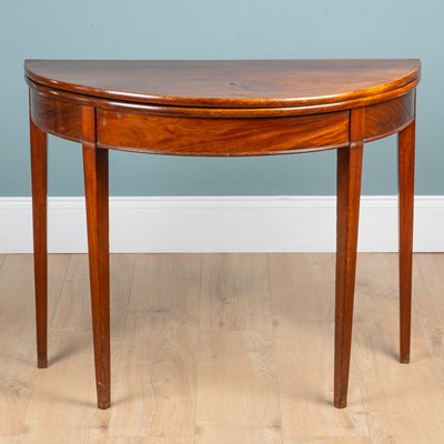 Lot 374 - A Georgian mahogany demi-lune tea table