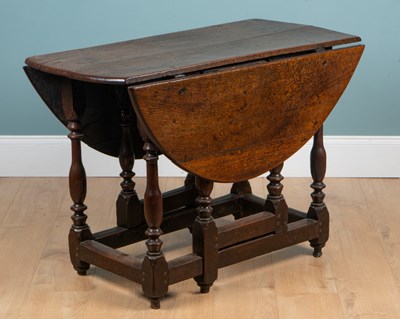 Lot 1243 - An 18th century oak gateleg table