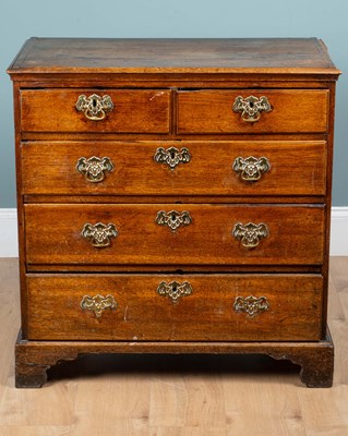 Lot 1093 - A small George III oak chest of drawers