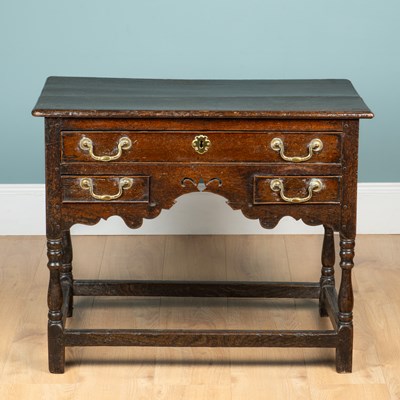 Lot 1106 - An 18th century oak lowboy