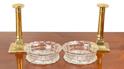 Lot 145 - A pair of Regency bottle coasters and a pair of candlesticks