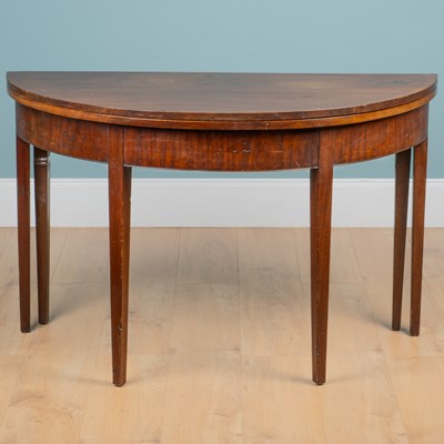 Lot 422 - A 19th century mahogany fold-over demi-lune tea table