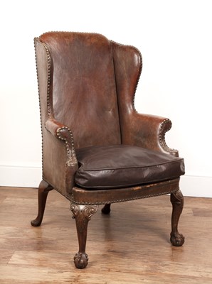 Lot 31 - Leather wingback armchair in the Georgian...