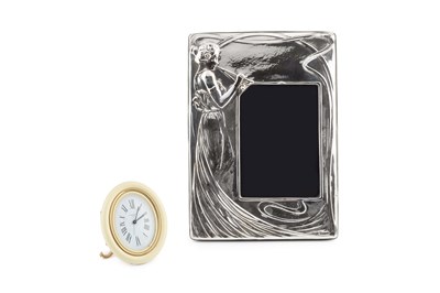Lot 556 - An oval easel alarm clock by Cartier, with...