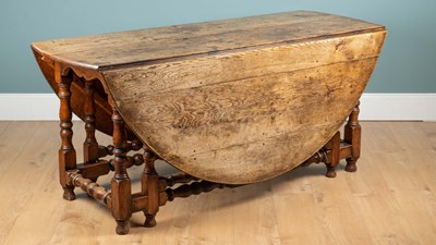 Lot 1137 - An 18th century ash and elm gateleg table.