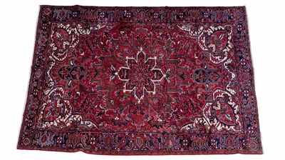 Lot 1241 - An early 20th century hand-woven Heriz carpet