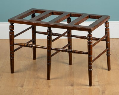 Lot 1201 - An Arts & Crafts stained beech luggage rack